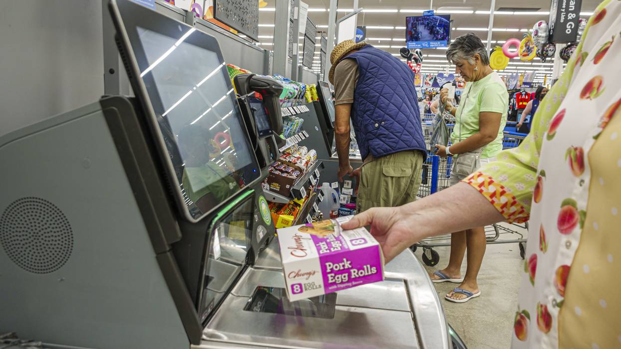 Miami Doral Florida, Walmart Supercenter, close up of self checkout register screen, hand holding Chung's pork egg rolls scanning item