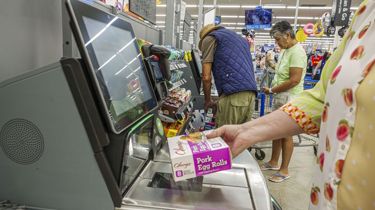 Miami Doral Florida, Walmart Supercenter, close up of self checkout register screen, hand holding Chung's pork egg rolls scanning item