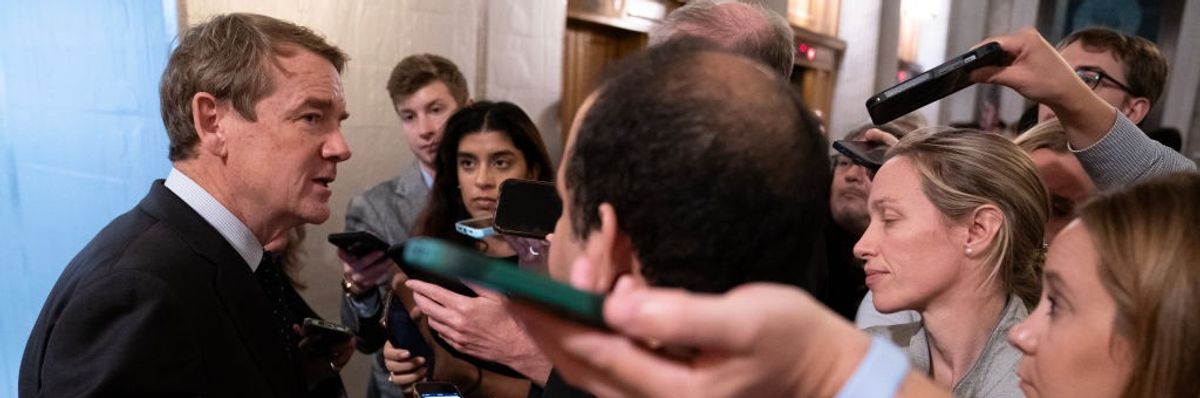Michael Bennet speaks to reporters.