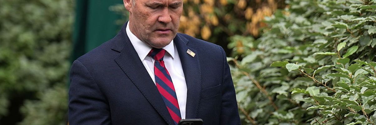 Michael Waltz looks at his phone