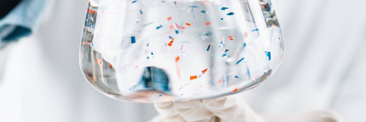 Microplastics Laboratory Analysis. Scientist Observing Microplastics Or Tiny Plastic Particles