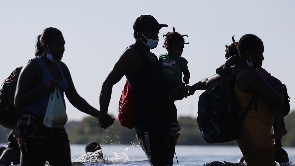 Migrants cross Rio Grande into Del Rio, Texas