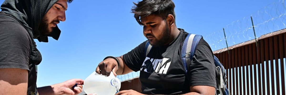 migrants drinking water