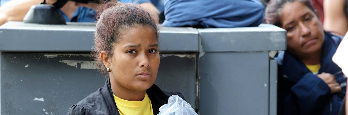 Migrants from Central and South America wait near the residence of U.S. Vice President Kamala Harris