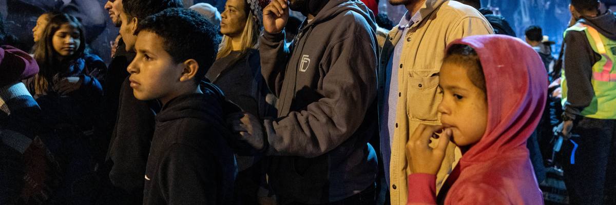 Migrants gather outside of a shelter