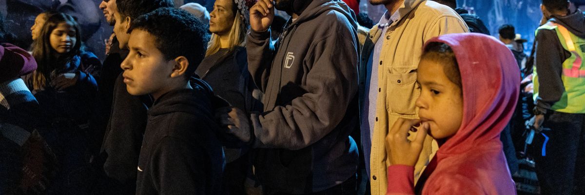 Migrants gather outside of a shelter