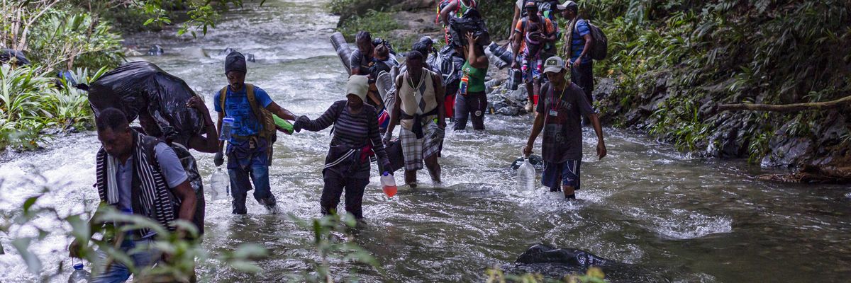 Migrants, most of them Haitians, cross the dangerous border between Panama and Colombia