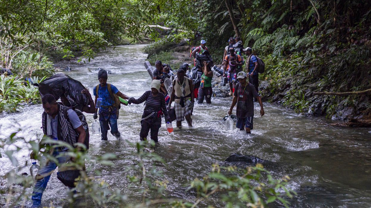 Migrants, most of them Haitians, cross the dangerous border between Panama and Colombia