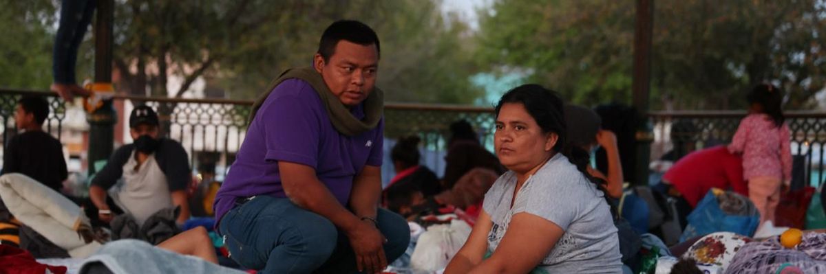Migrants wait to seek asylum in the U.S., at an encampment in Mexico