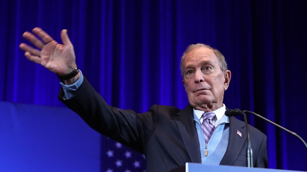 Mike Bloomberg gestures at the audience.