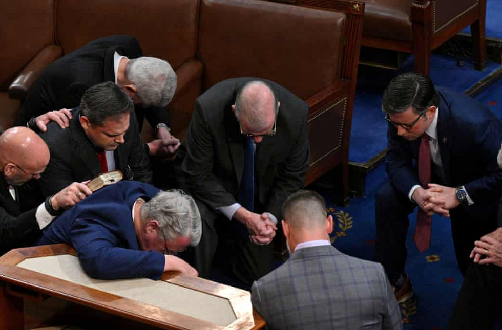 Mike Johnson and other GOP reps pray on the House floor.