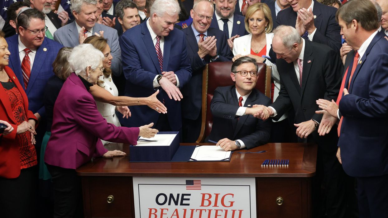 Mike Johnson shakes hands after signing OBBB.