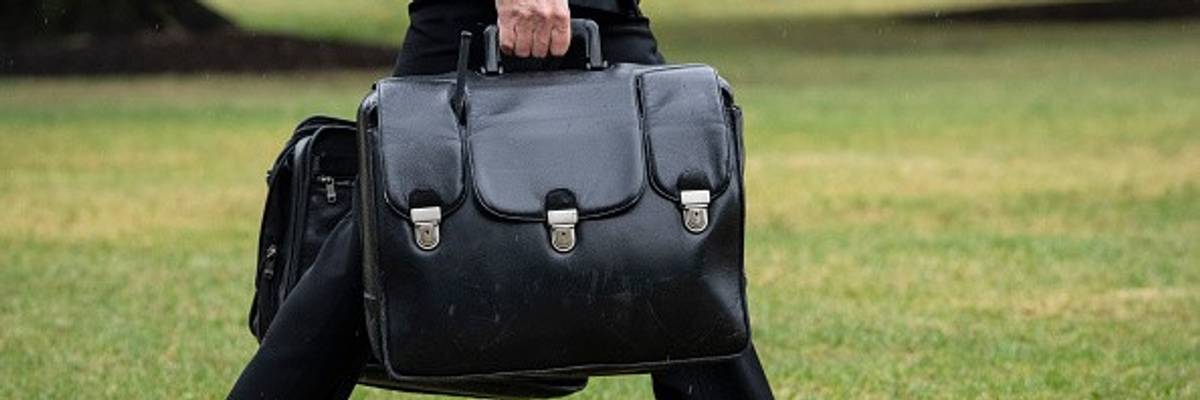 Military aide carries nuclear football.