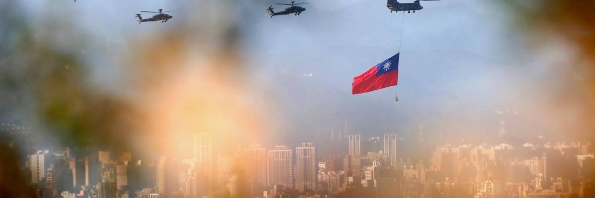 Military helicopters carrying tremendous Taiwan flags conduct a flyby rehearsal ahead of National Day celebration, near Taipei