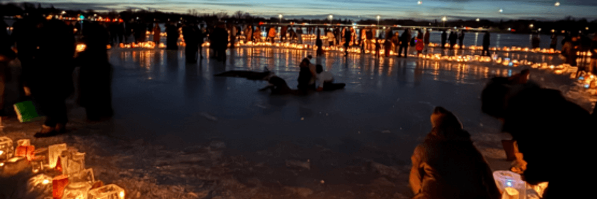 Minneapolis residents have a candlelit vigil on a frozen lake to protest ICE.