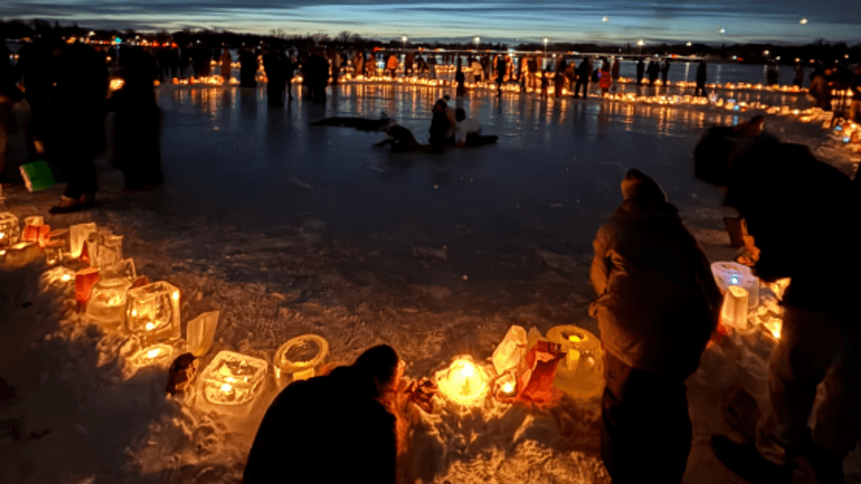 Minneapolis residents have a candlelit vigil on a frozen lake to protest ICE.