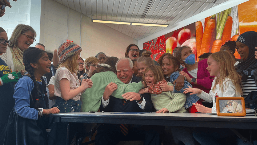 Minnesota Gov. Tim Walz hugs students