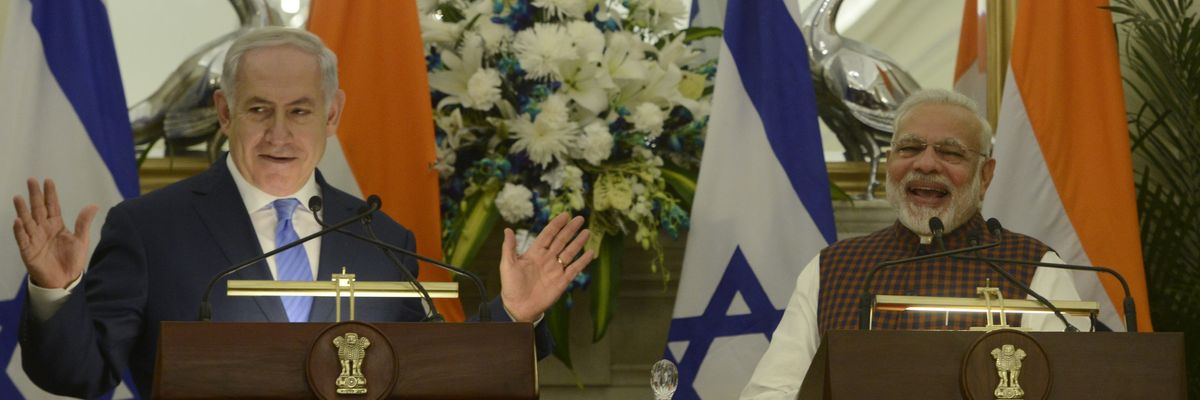 Modi and Netanyahu speak at podiums with flags. 