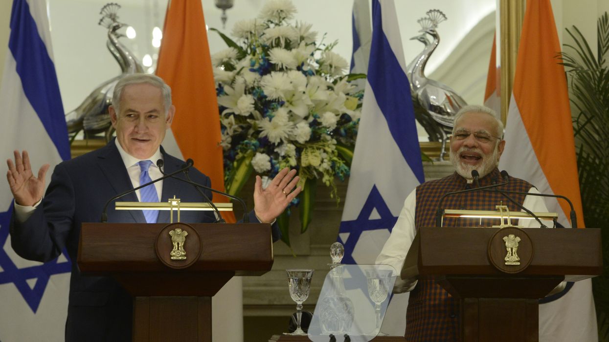 Modi and Netanyahu speak at podiums with flags.