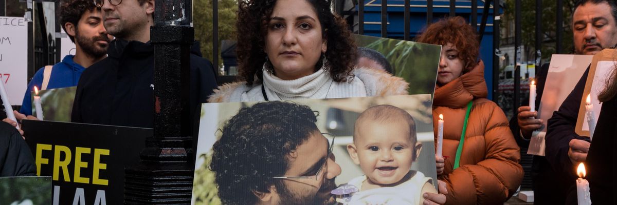 Mona Seif (C), sister of the jailed British-Egyptian human rights activist Alaa Abd el-Fattah, is joined by supporters during a vigil outside Downing Street to demonstrate concern for her brother
