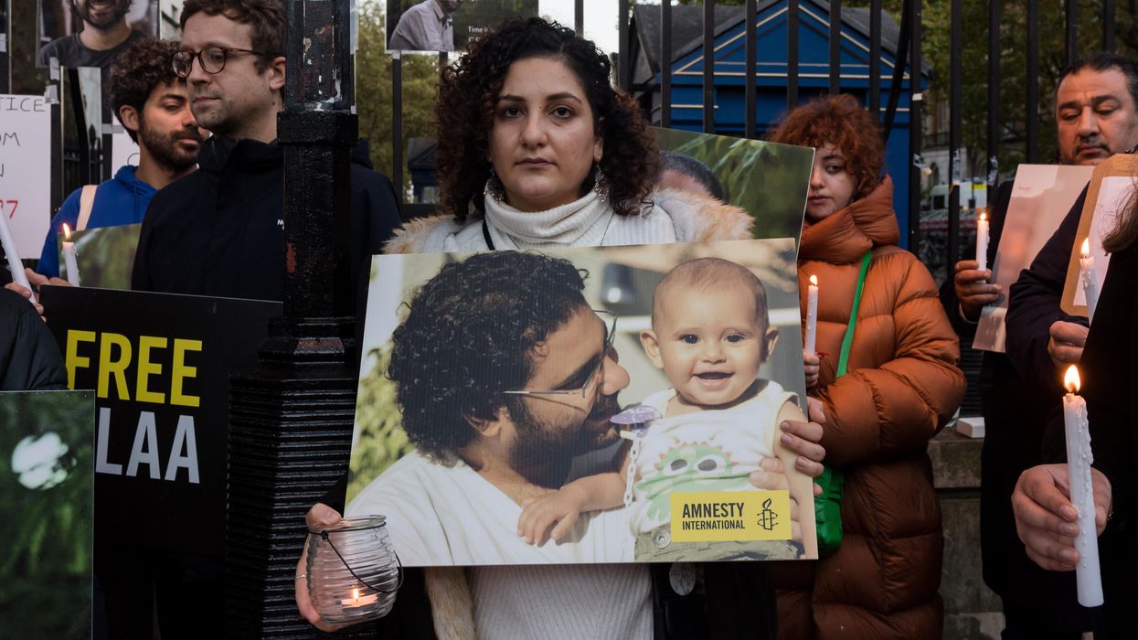Mona Seif (C), sister of the jailed British-Egyptian human rights activist Alaa Abd el-Fattah, is joined by supporters during a vigil outside Downing Street to demonstrate concern for her brother