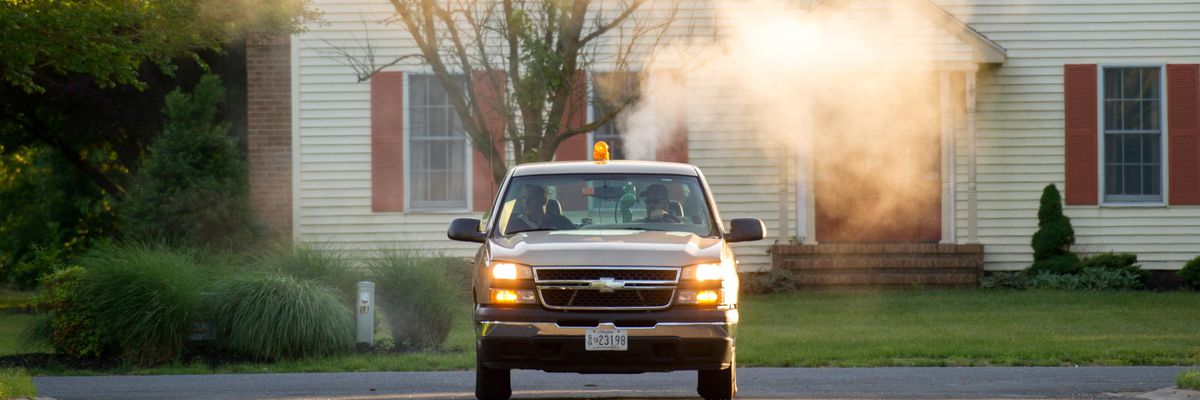 Moquito truck spraying neighborhood