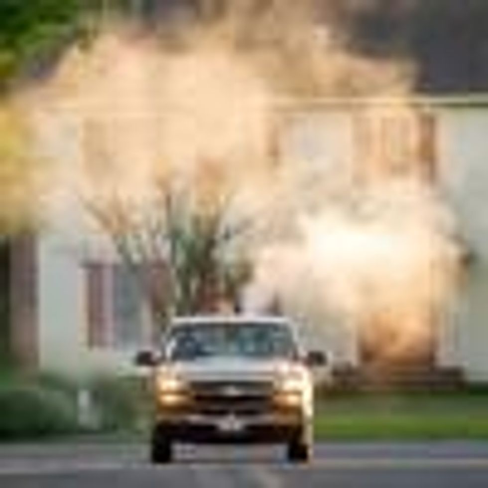 Moquito truck spraying neighborhood