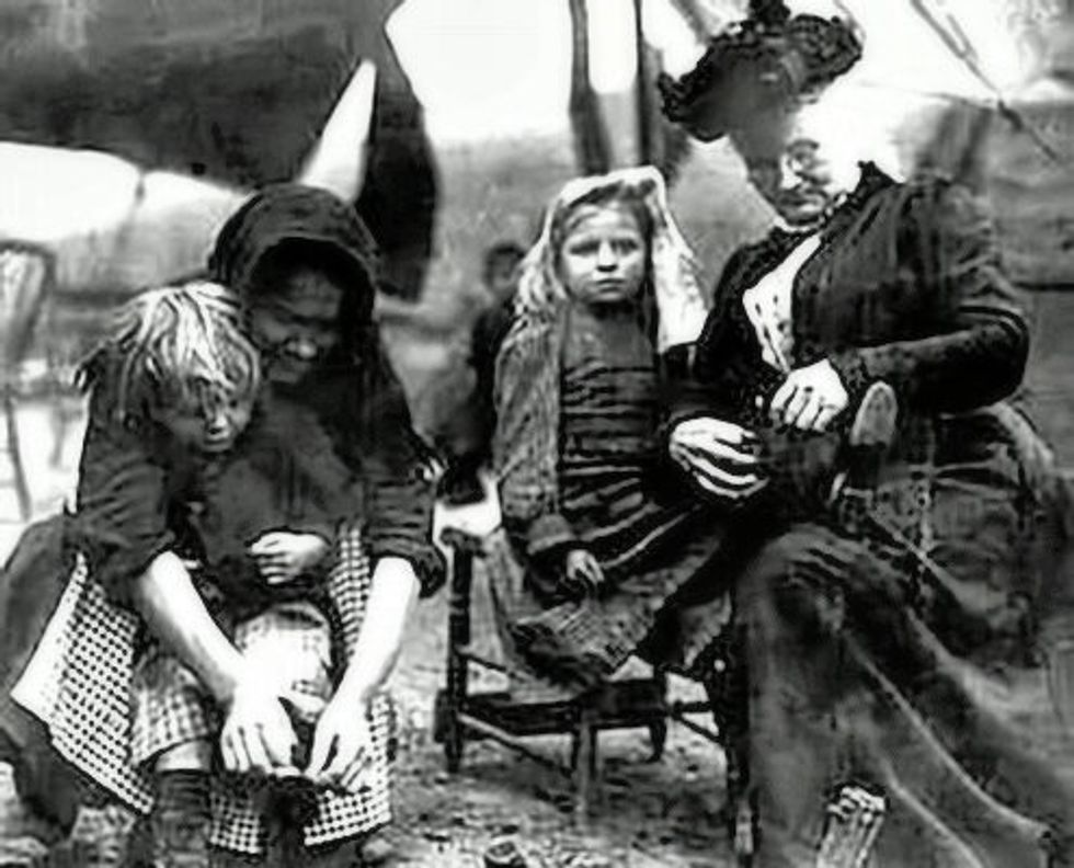 Mother Jones and a mother help kids camped out on the Children's March tie their shoes