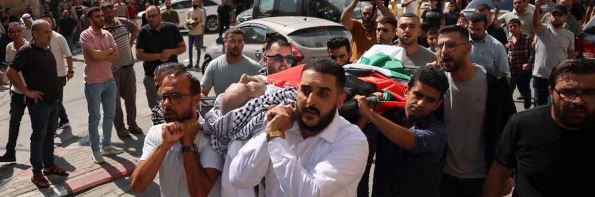 Mourners carry the body of 66-year-old Palestinian man Ziad Abu Ehlayyel during his funeral procession