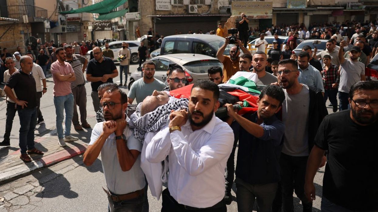 Mourners carry the body of 66-year-old Palestinian man Ziad Abu Ehlayyel during his funeral procession