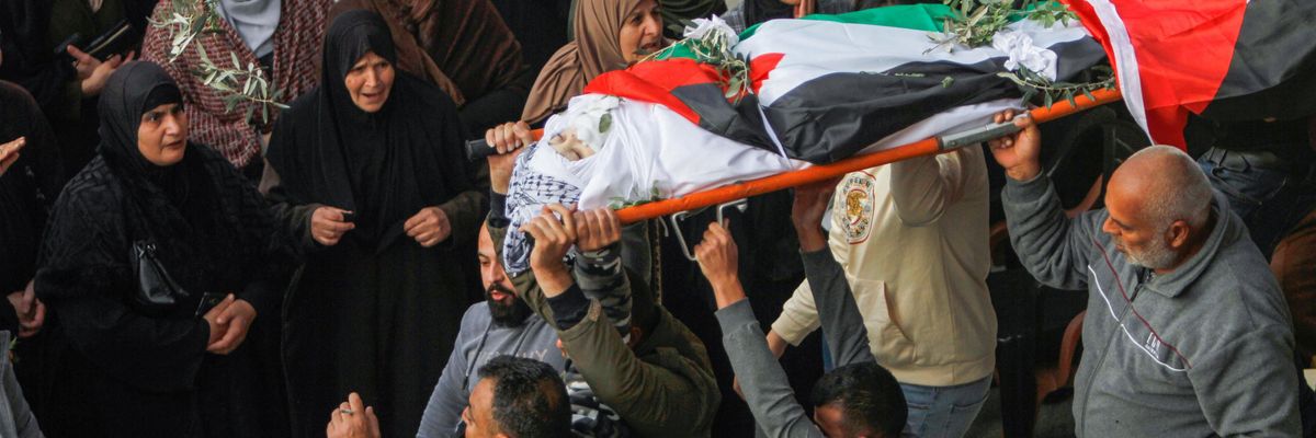 Mourners carry the body of a 15-year-old Palestinian killed by Israeli forces