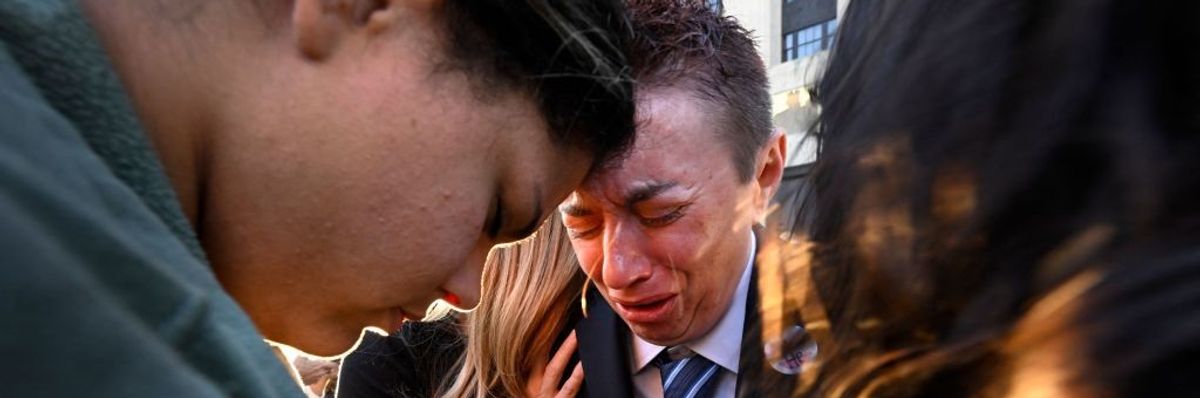 Mourners cry at vigil for Nashville victims.