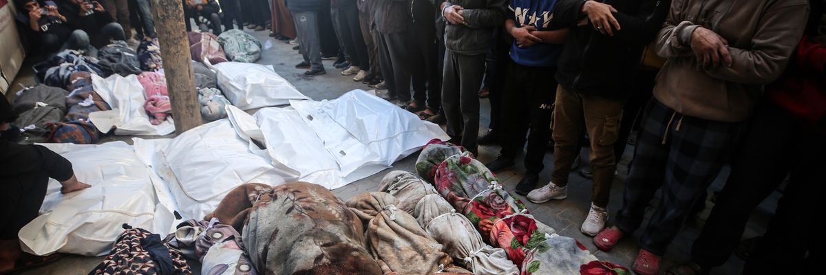 Mourners gather near the bodies of Palestinians killed in an Israeli strike