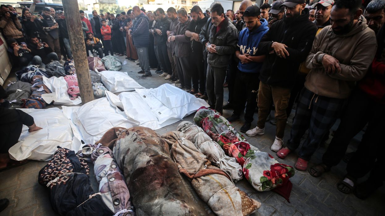 Mourners gather near the bodies of Palestinians killed in an Israeli strike