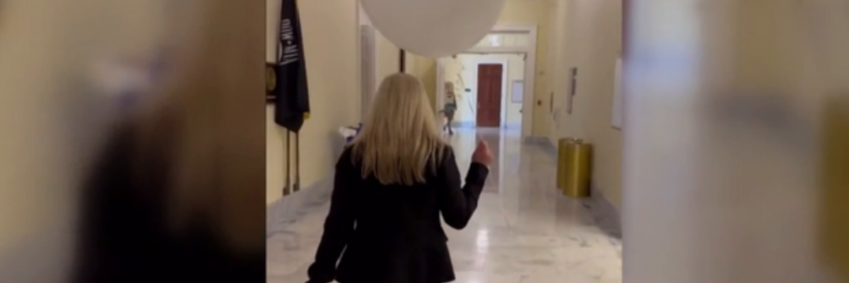 MTG parades the Halls of Congress with what she called "just an innocent white balloon.