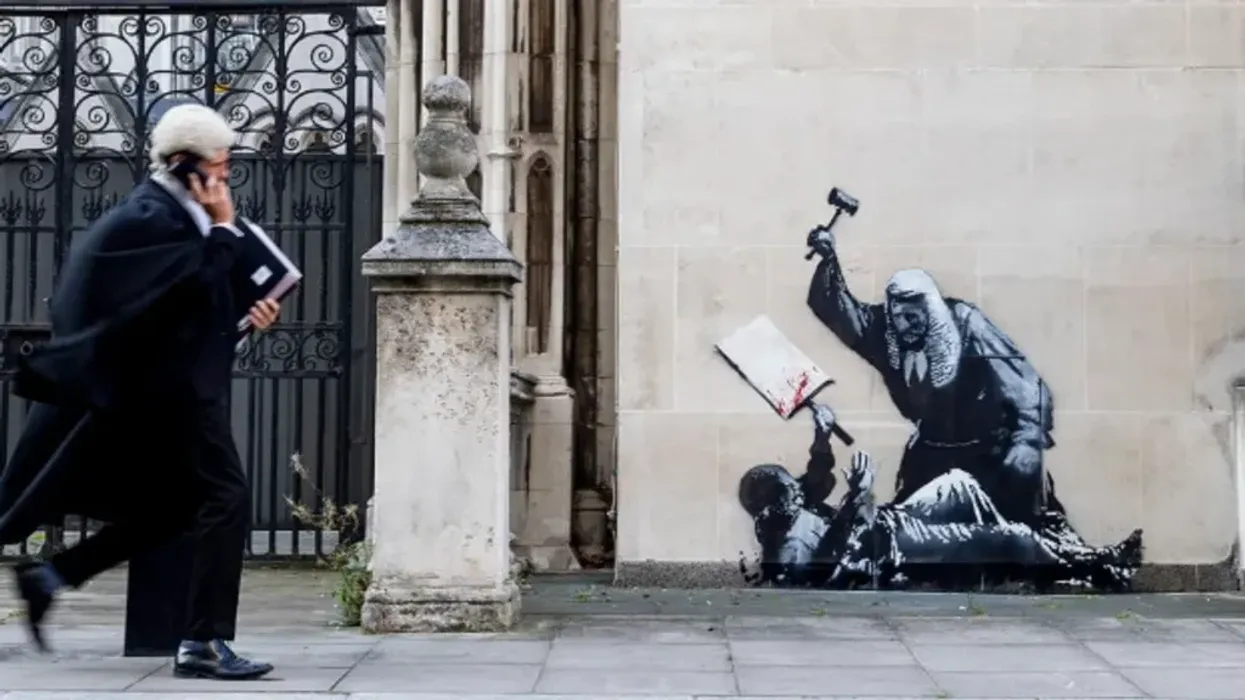 Mural by Banksy depicting a judge beating a protester with a mallet