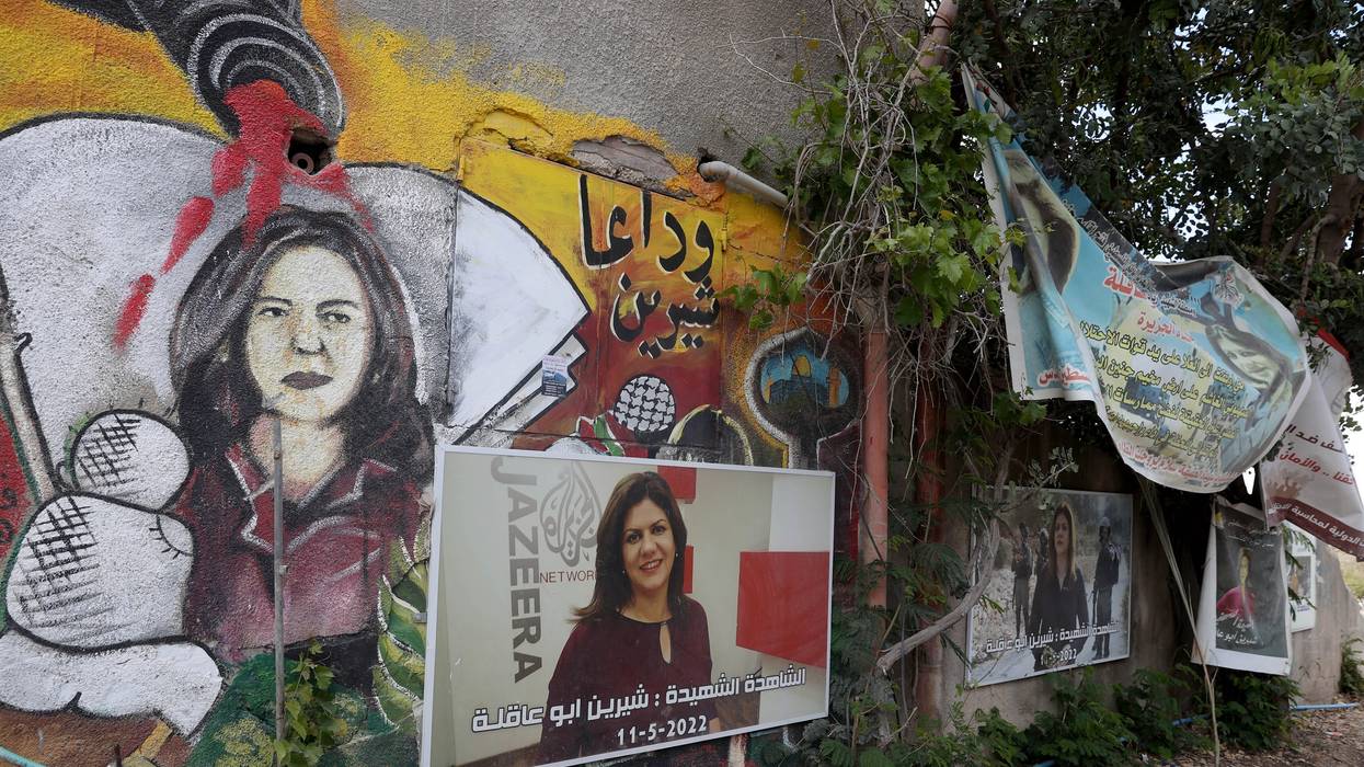 Murals and posters with the portrait of Shireen Abu Akleh, an Al Jazeera reporter killed by Israeli forces last year, are seen at the area where she died in Jenin, West Bank on April 30, 2023. 