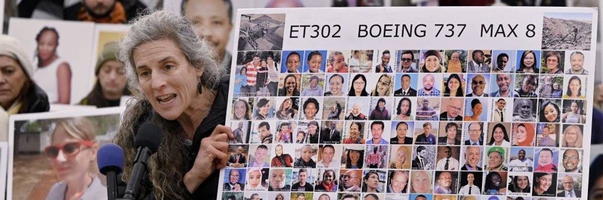 Nadia Milleron holds a photo board of those who died in the Boeing 737 MAX crash in Ethiopia.