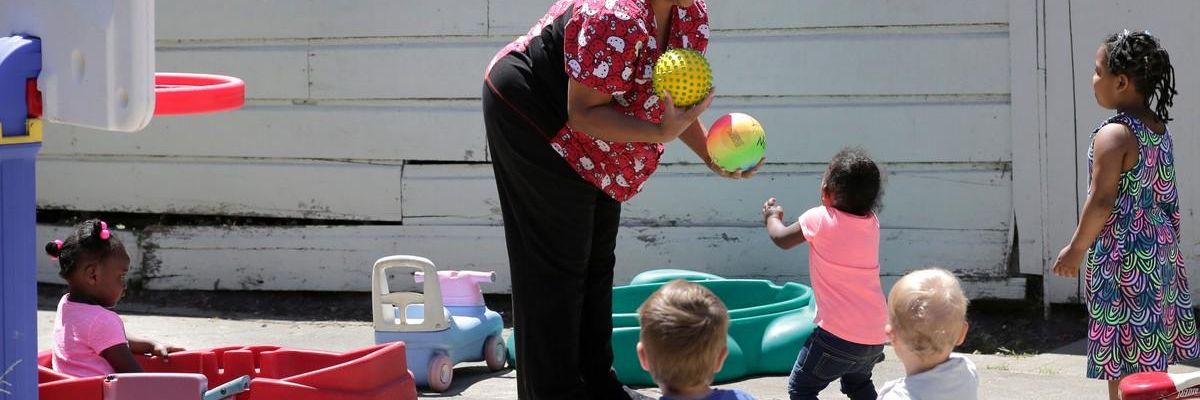 Nancy Harvey, who runs a daycare service out of her home in Oakland, California, plays with children on May 19, 2017.