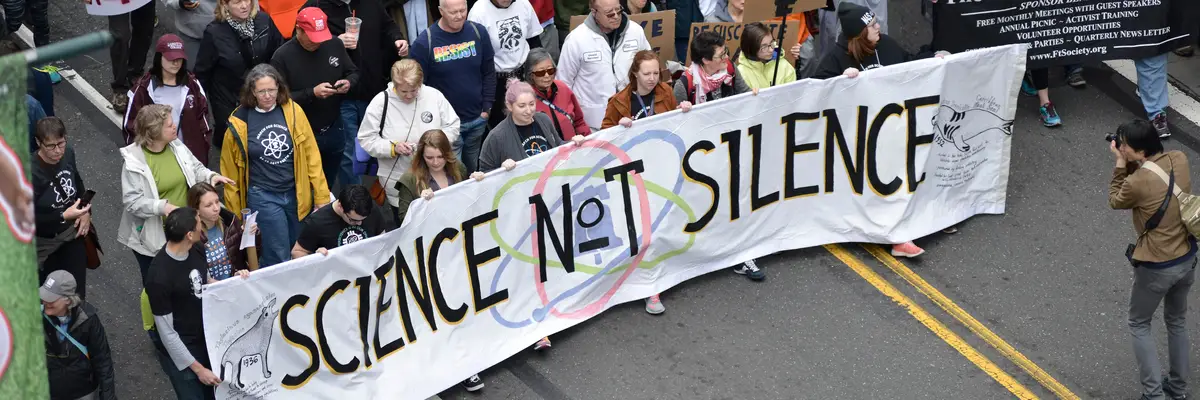 National March for Science in Philadelphia featuring "Science not Silence" banner.