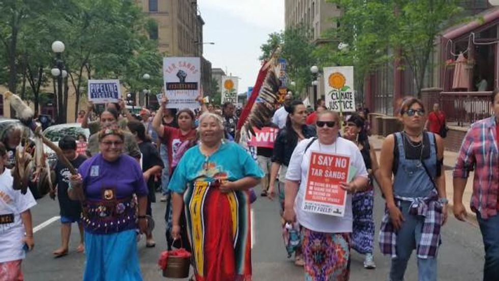 Native women carrying sacred water led a climate march against Big Oil pipelines in St. Paul, Minnesota on June 6. (WNV / David Goodner)