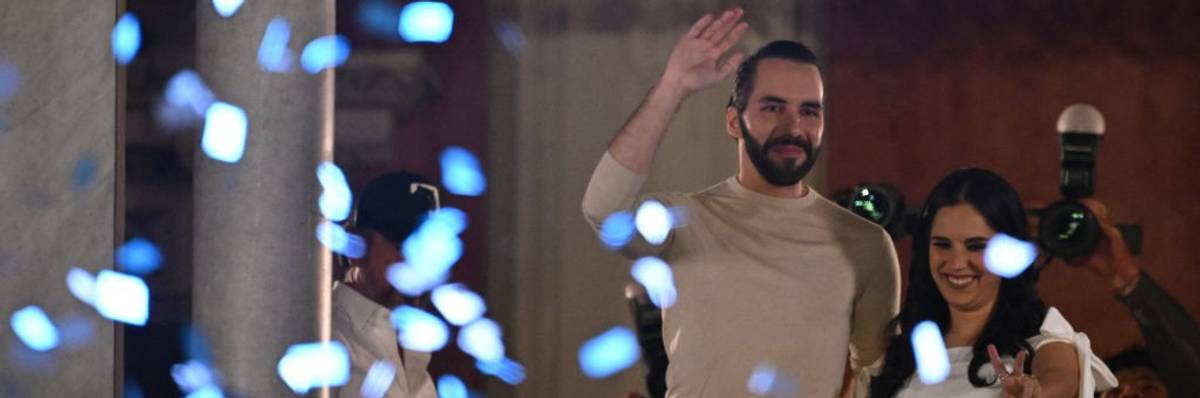 Nayib Bukele and his wife Gabriela Rodriguez greet supporters celebrating his reelection