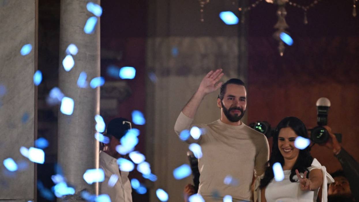 Nayib Bukele and his wife Gabriela Rodriguez greet supporters celebrating his reelection