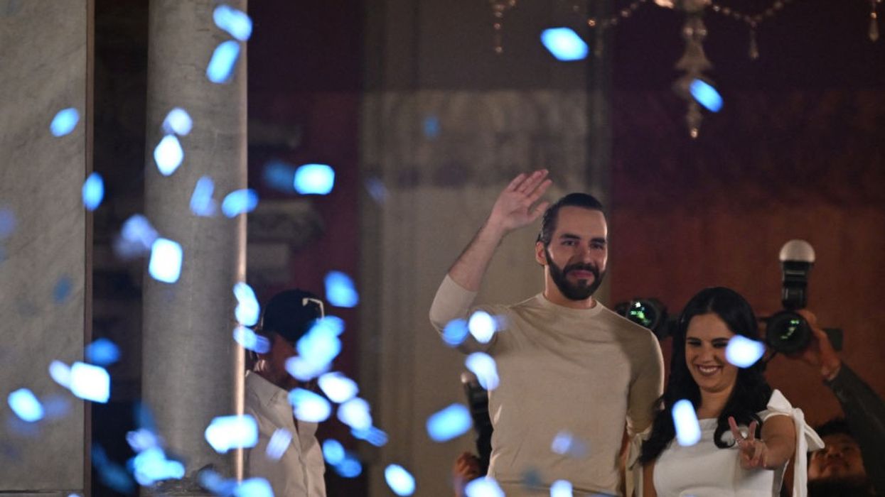 Nayib Bukele and his wife Gabriela Rodriguez greet supporters celebrating his reelection