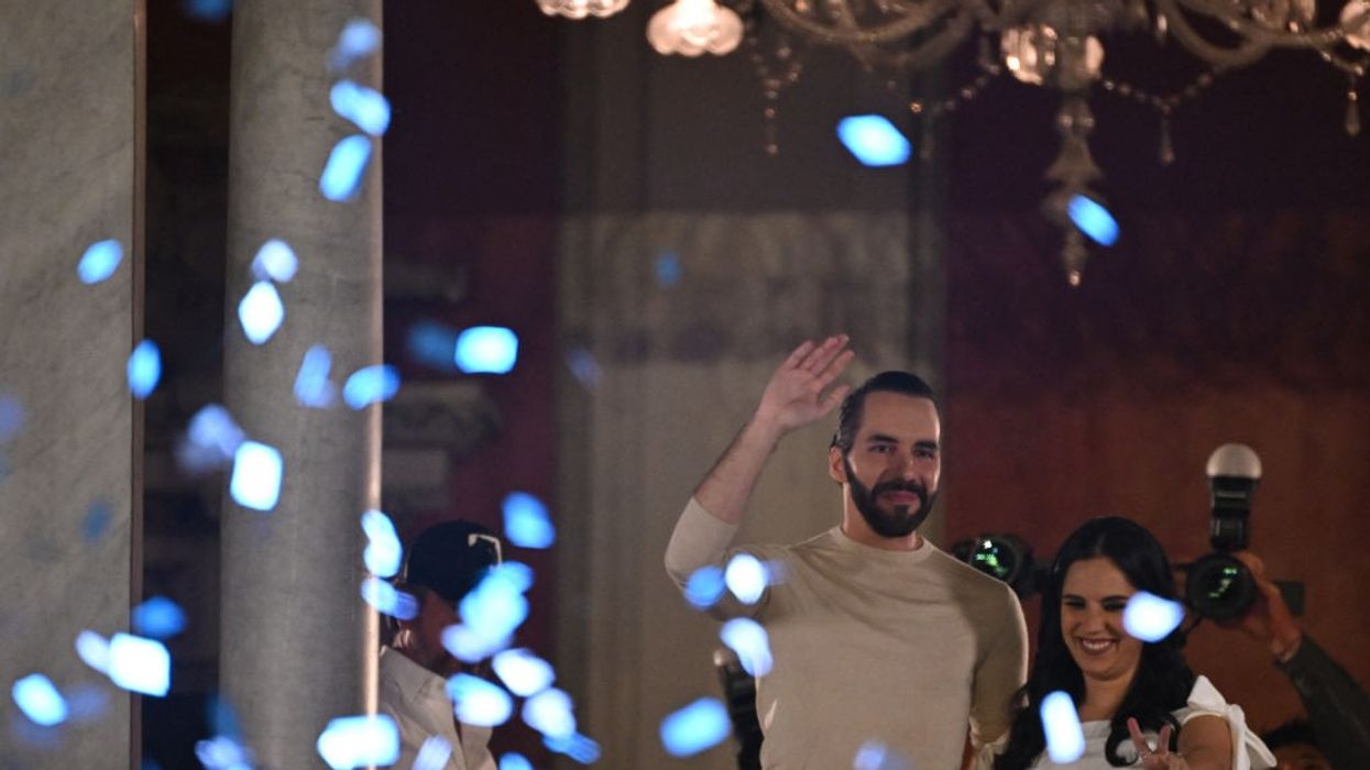 Nayib Bukele and his wife Gabriela Rodriguez greet supporters celebrating his reelection