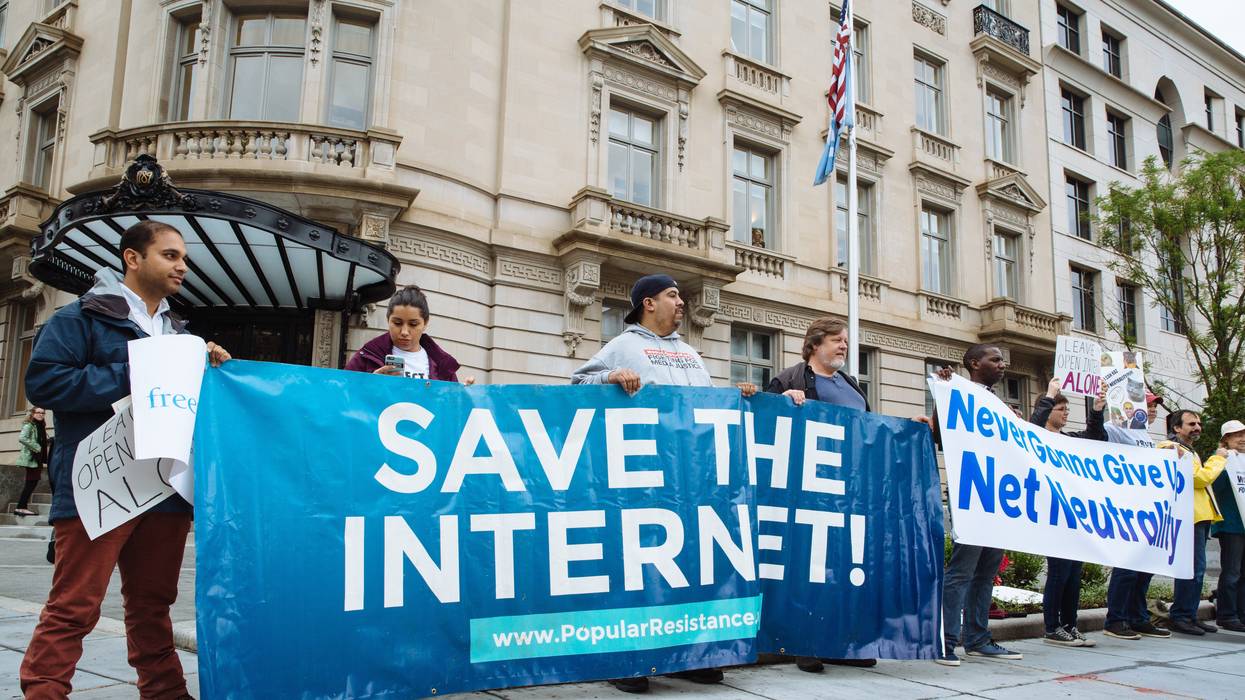 net neutrality supporters hold banners