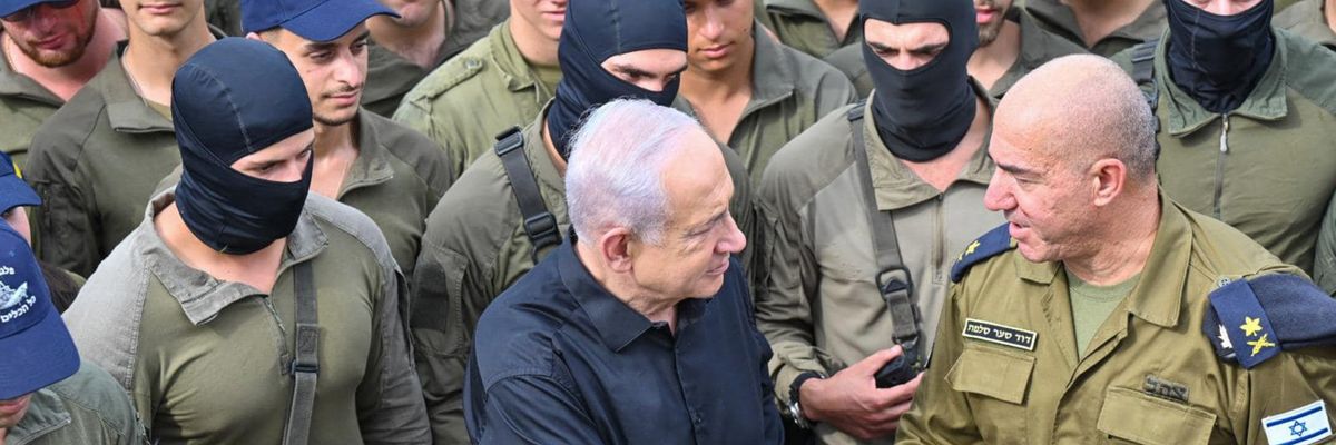 Netanyahu shakes hands with an Israeli naval commander while surrounded by troops in black balaclavas.
