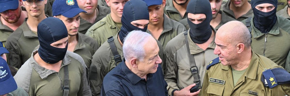 Netanyahu shakes hands with an Israeli naval commander while surrounded by troops in black balaclavas.