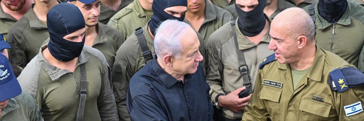 Netanyahu shakes hands with an Israeli naval commander while surrounded by troops in black balaclavas.