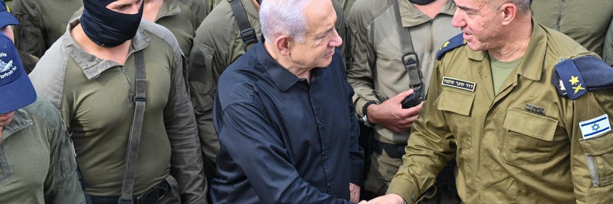 Netanyahu shakes hands with an Israeli naval commander while surrounded by troops in black balaclavas.